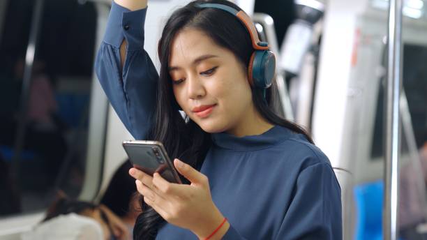 istock Young woman using mobile phone on public train 1284695319