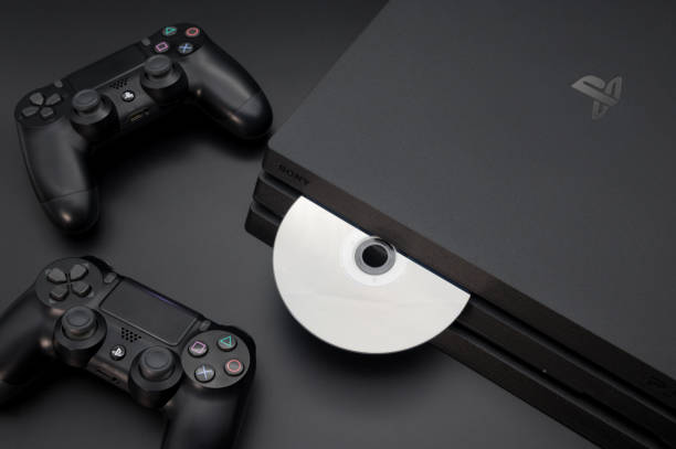 Sony Play Station 4 Pro gaming console isolated on the black table background with the joystick controller next to it. Eject the dvd compact disc with the video game Chengdu, Sichuan province, China - November 26, 2019: Close-up view of digital gaming console Sony Playstation 4 Pro usb port photos stock pictures, royalty-free photos & images
