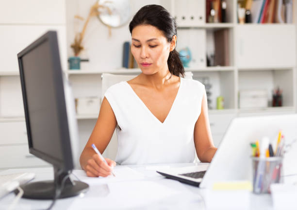 istock Woman manager working  with laptop and documents in office 1284696518