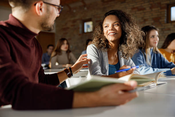 istock Happy university students talking on a class in the classroom. 1284697035