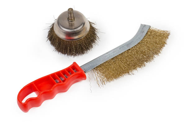 Manual wire brush with brass corrugated wire and round wire brush in the form of a nozzle for grinders, drills and other power tools on a white background