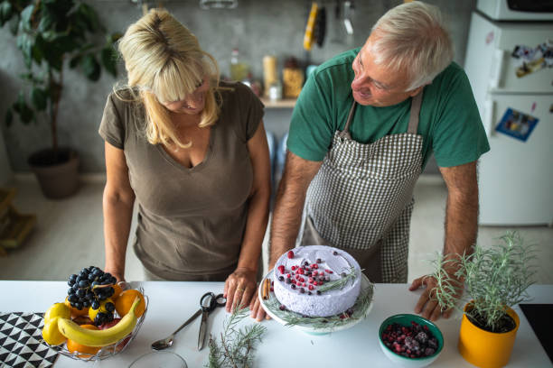 istock Senior couple prepared tasty cake in modern kitchen 1284700099