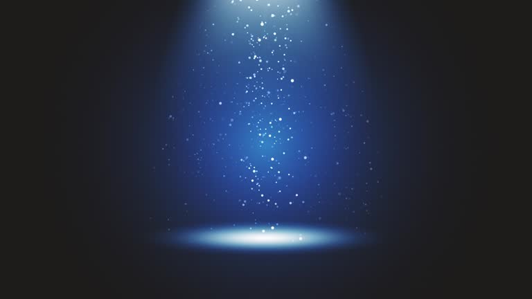 Stage light shining at blue studio. Big spotlight illuminate the scene from sky. Rays of lights on stage with glowing sparkles. All the lights gather in one point. The concepts of performance arts, party, lighting, event, celebration, UFO, teleportation