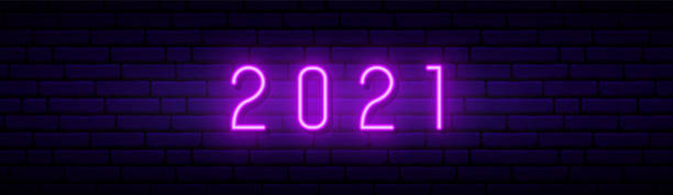 istock New Year 2021 neon sign. Glowing violet number 2021 on dark brick wall background. Horizontal neon signboard. Stock vector illustration. 1284701642