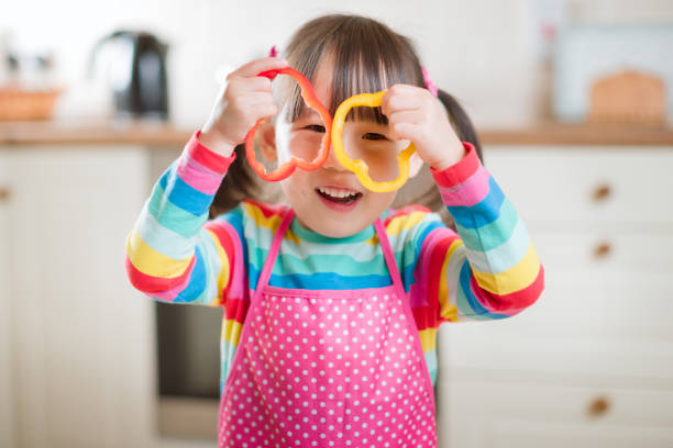 istock young girl put pepper ring on her face as glass against real kitchen background 1284704365