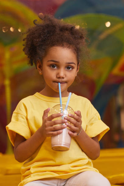 istock African girl drinking cocktail 1284705099