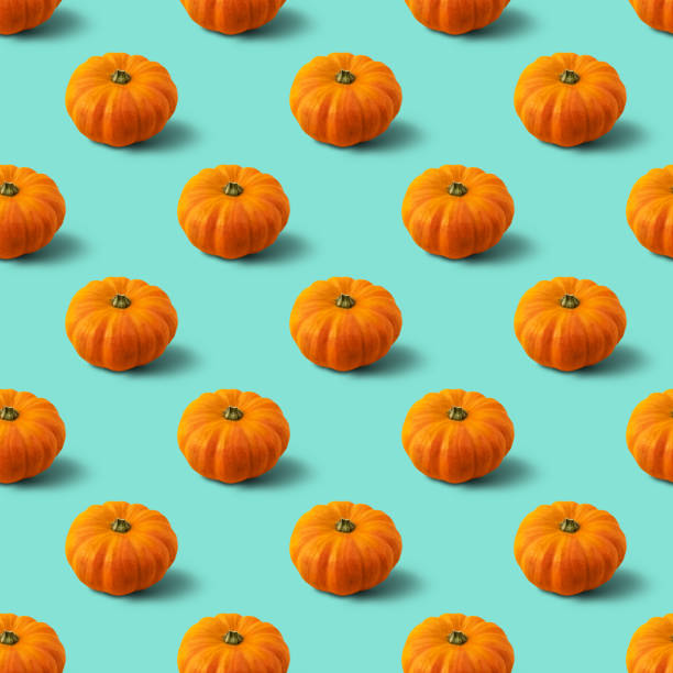 Seamless pattern with pumpkin on mint background. Autumn abstract background. Minimal vegetable concept. Seamless pattern with pumpkin on mint background. Autumn abstract background. Minimal vegetable concept. Halloween gourd photos stock pictures, royalty-free photos & images