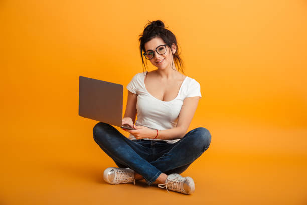 istock Happy pretty young woman using laptop computer. 1284710631