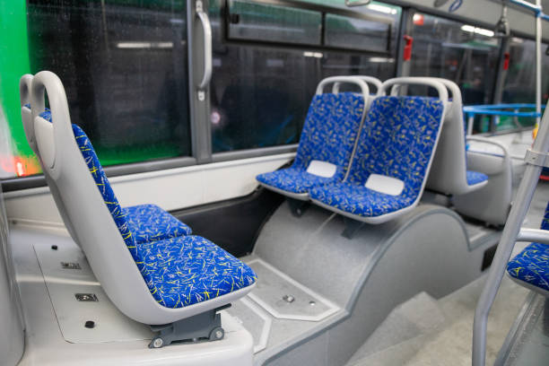 istock Empty bus interior. Blue seats without passengers. Public transport. Transportation of passengers by public transport. Ergonomic interior of the bus. Travel to other cities. 1284711292