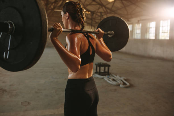 istock Woman doing squats with barbell 1284711914