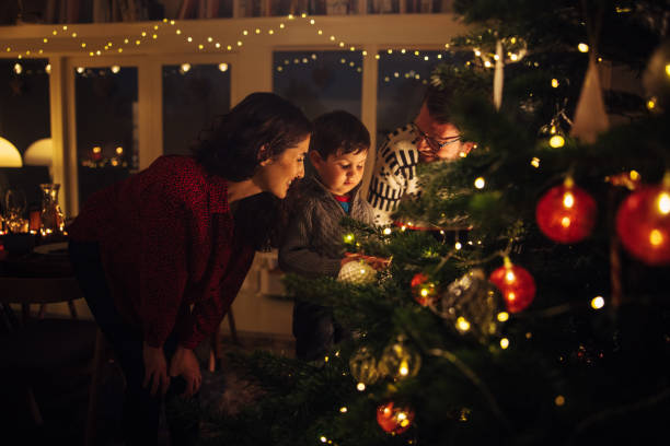 istock Family at christmas tree 1284714303