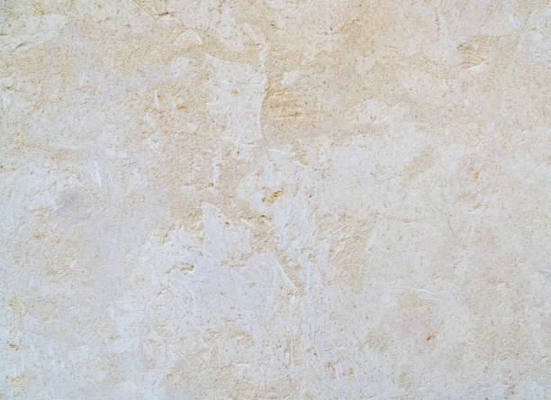 istock Decorative beige limestone tile on the facade of the building as a background or backdrop. brick wall texture background. Brickwork or stonework flooring interior rock pattern 1284714316