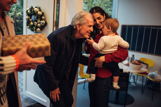 istock Senior couple visiting family for Christmas dinner 1284714445