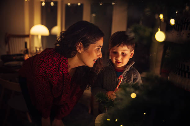 istock Mother and son decorating Christmas tree 1284714663
