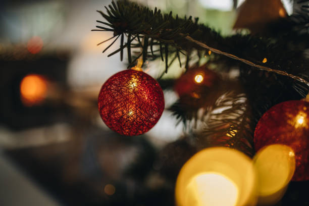 istock Ornaments hanging on a christmas tree 1284715297