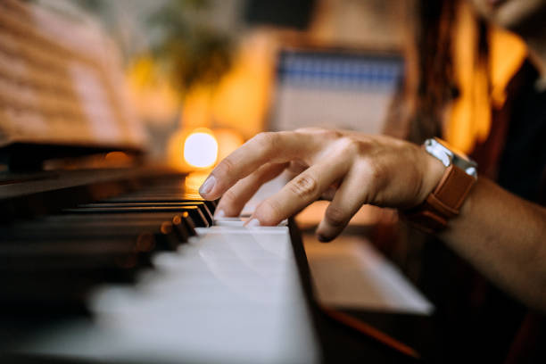 istock Close up on musician playing piano 1284715591