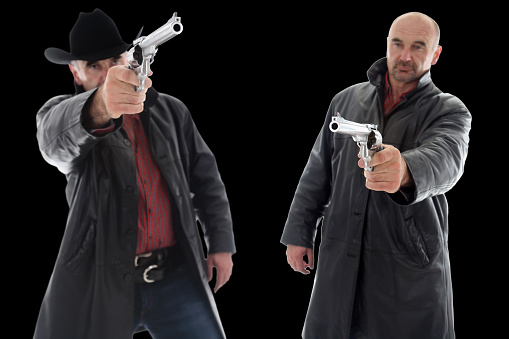 Armed bandits in action, isolated on black background