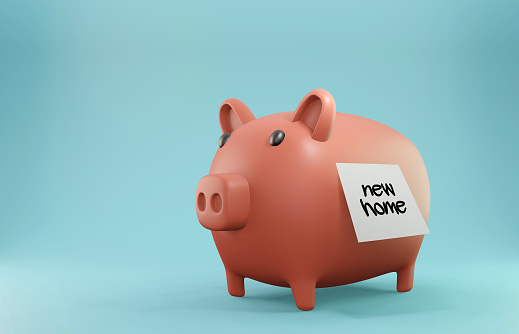 Saving money for the New Home. Pink piggy bank and sticky note paper. Horizontal composition with copy space.