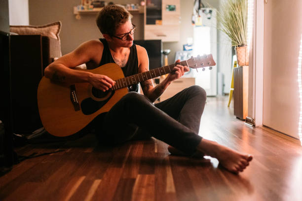 istock Musician Playing On Acoustic Guitar At Home 1284720071