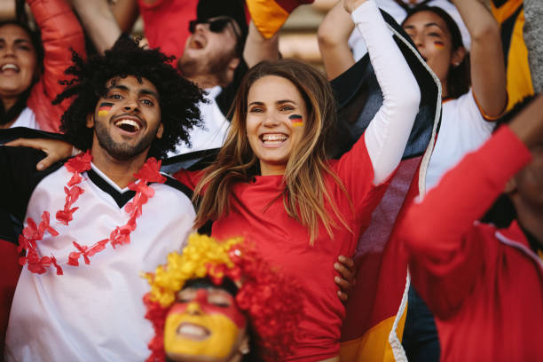 istock Excited sports fans cheering their team 1284722479