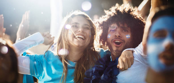 istock Cheering couple at football match 1284723249