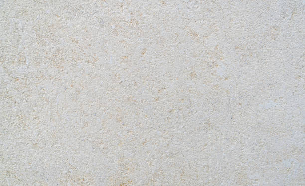 istock Decorative beige limestone tile on the facade of the building as a background or backdrop. brick wall texture background. Brickwork or stonework flooring interior rock pattern 1284723620