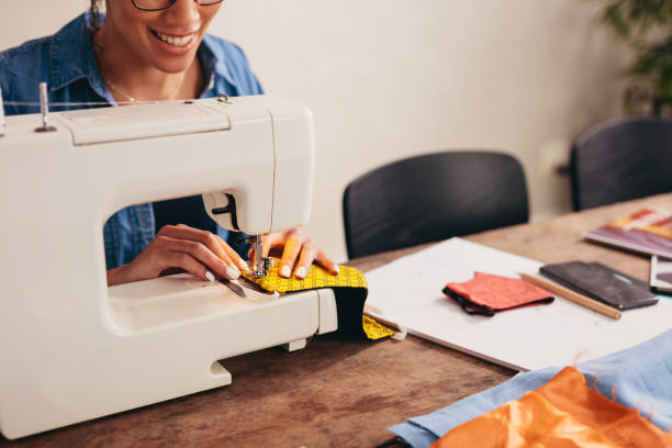 istock Woman hands sewing a face mask at home 1284723738