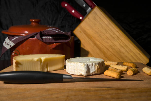 istock Goat cheese and monk's head cheese on a wooden table 1284724004
