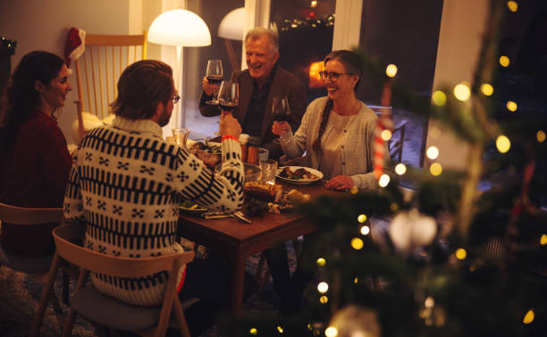 istock Family enjoying Christmas dinner with drinks 1284724131