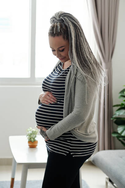 istock Pregnant woman with dreadlocks 1284724952