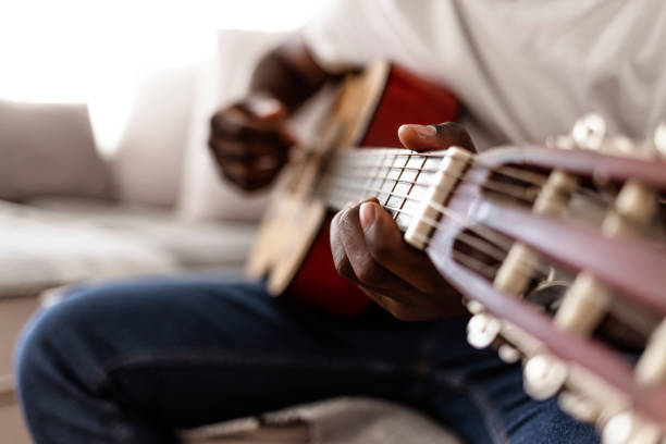 istock Musician with string musical instrument tuning acoustic guitar 1284729064