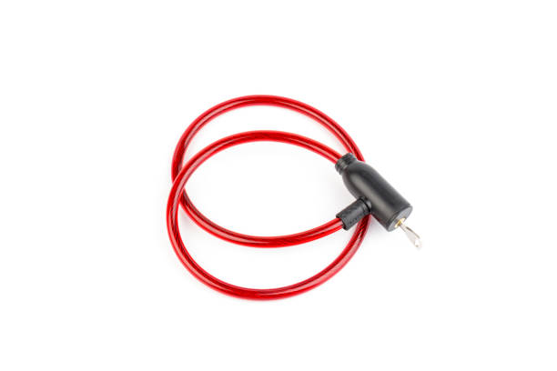 istock Flexible red bicycle cable with key on white background.  Security and safety concept. 1284730373