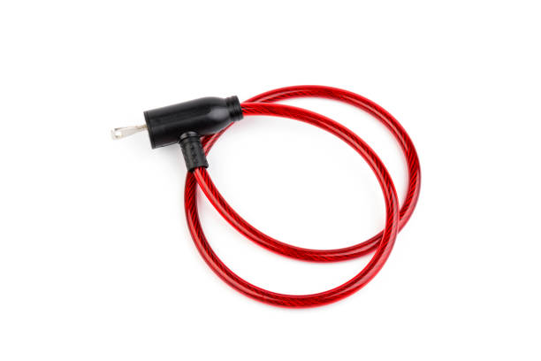 istock Flexible red bicycle cable with key on white background.  Security and safety concept. 1284730459