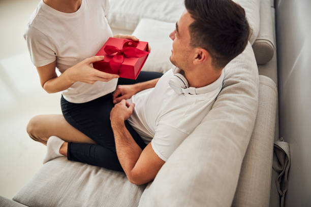 istock Young husband receiving the gift from his wife 1284732970