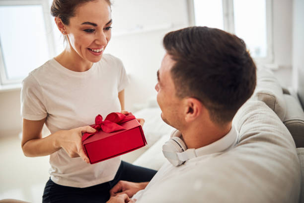 istock High-spirited wife congratulating her husband on his birthday 1284732971