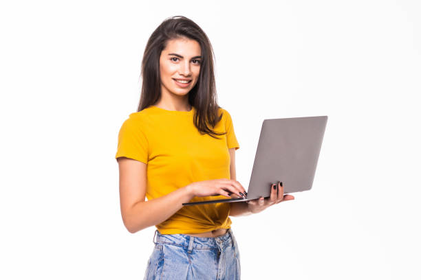 istock Young woman holding a laptop isolated on white background 1284734973