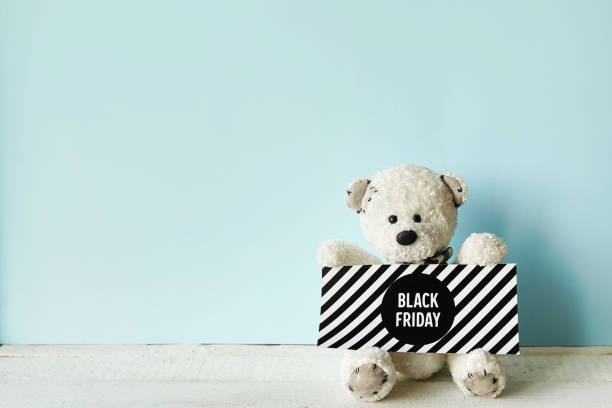 istock teddy bear with sign black friday on blue background with copy space 1284736099