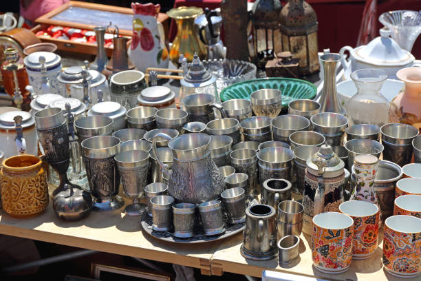 Vienna, Austria - July 11, 2015: Metal Jugs Cups Mugs Bric Brac Stall at Naschmarkt Flea Market Saturday in Wien, Austria.
