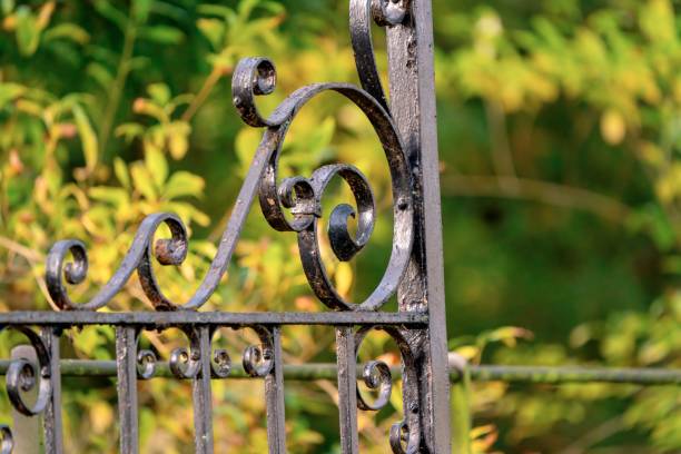 istock Ornate ironwork on top of a metal gate painted black 1284736468