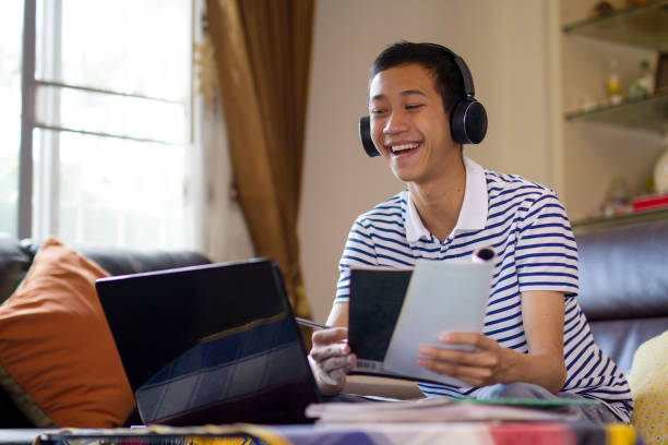 istock Young asian man video calling on laptop at home 1284739451