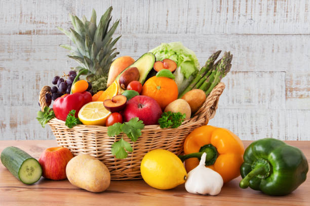 istock Fruits and vegetables in a basket on a wood background 1284740072