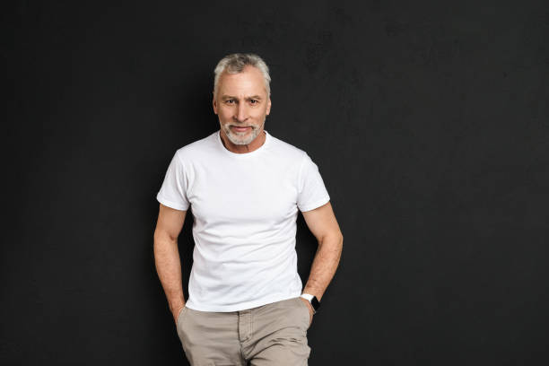 istock Handsome mature old man standing isolated 1284741019