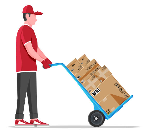 Courier with barrow full of boxes isolated Courier with barrow full of boxes isolated on white. Metallic two wheeled trolley with cardboard box and delivery man. Hand truck dolly icon. Transportation warehouse. Cartoon flat vector illustration mover delivery person box hand truck stock illustrations