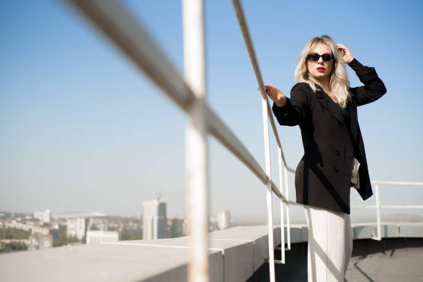 istock Woman standing at rooftop on a sunny autumn day. 1284744679