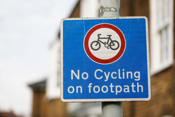 No cycling on footpath warning sign The red circle on this warning sign says "no", as does the wording on the blue background. A warning that is much ignored on London's streets. no cycling sign stock pictures, royalty-free photos & images