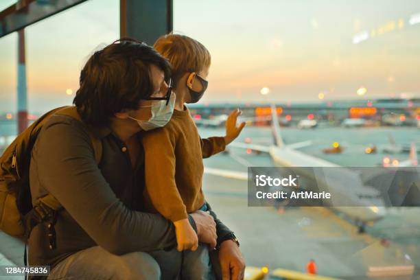 Family In Protective Face Masks In Airport During Covid19 Pandemic Stock Photo - Download Image Now