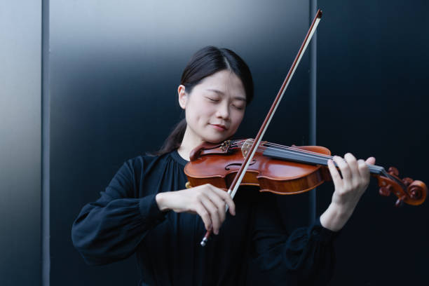 istock Asian woman playing the violin 1284746269