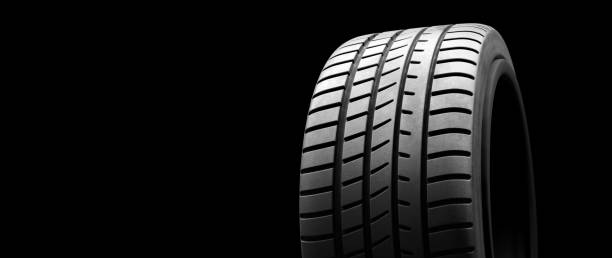istock New wheel tire close-up on black 1284747199