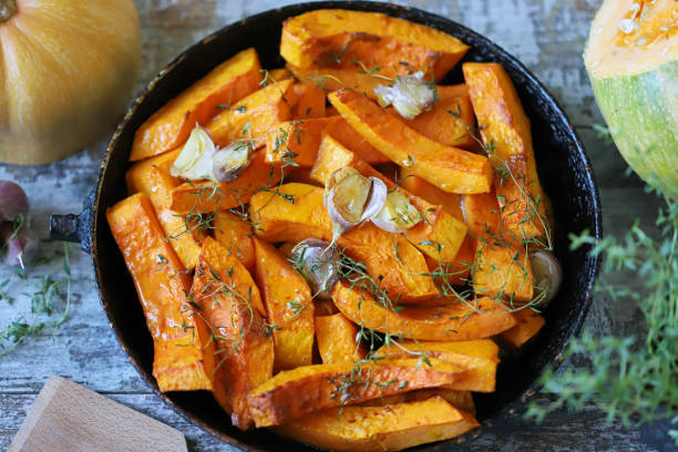 istock Sliced pumpkin in a pan with thyme and garlic. 1284749587