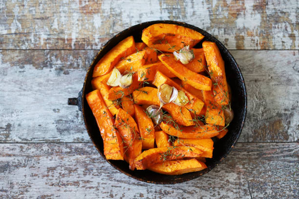 istock Sliced pumpkin in a pan with thyme and garlic. 1284749608